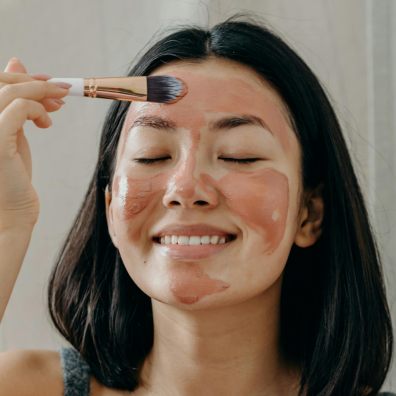 picture of a woman applying a face mask as part of a night time skincare routine