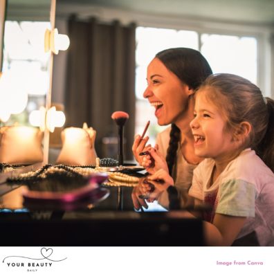 picture of a happy mum and daughter experimenting with makeup